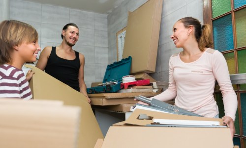Removal team sorting recyclable packaging and reusable household items in South Kensington