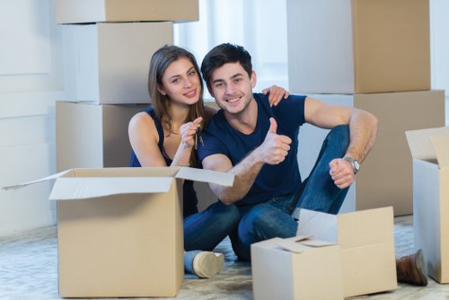Professional movers loading boxes and furniture outside a South Kensington property