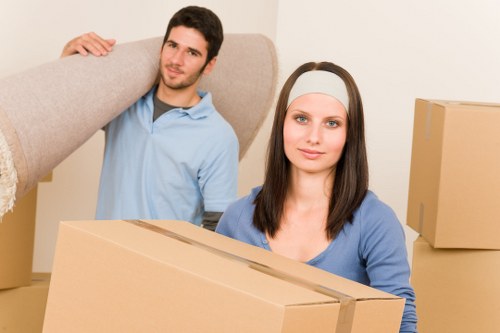 Helper loading furniture into a moving van for a local job