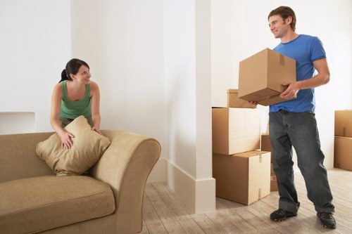 Staff wearing protective gear while moving furniture